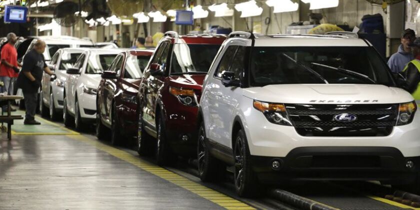 Ford Explorers, right, roll off the assembly line at the Chicago Ford Assembly | Associated Press