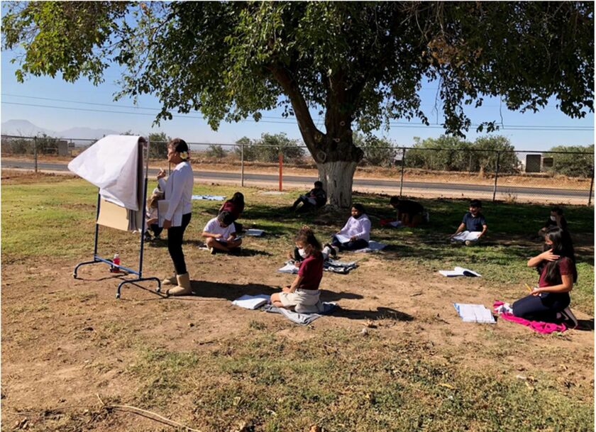 Staff members and students in Arizona’s Stanfield school district have made frequent use of outdoor spaces during the pandemic. Here, in November, a third-grade class had a snack and learning time outside.