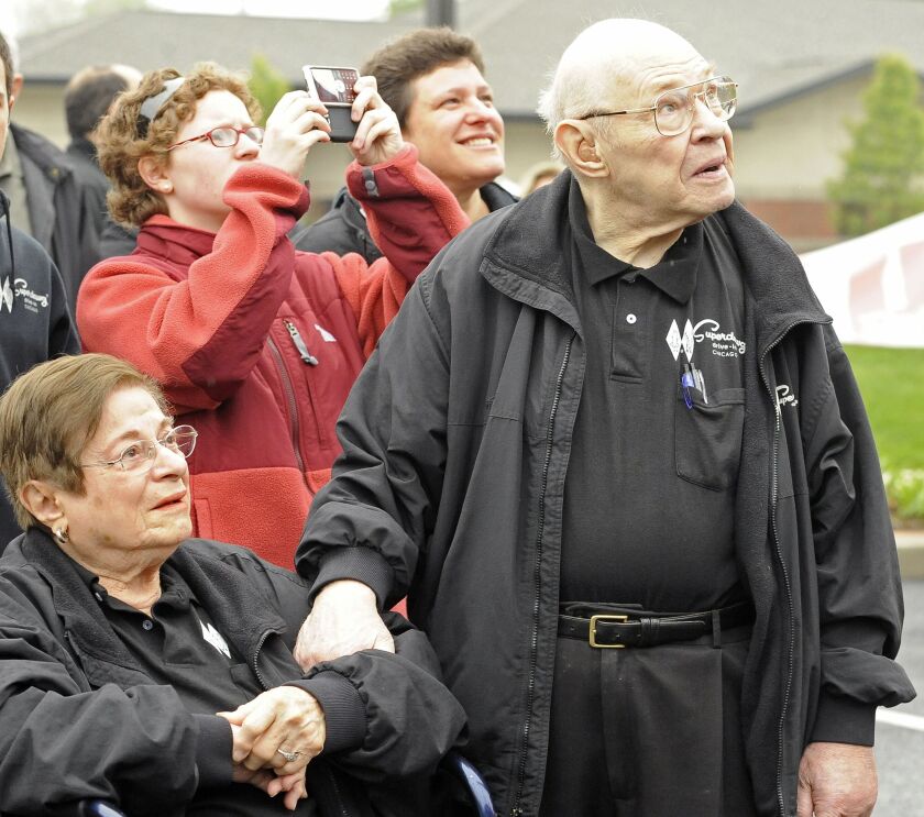 Superdawg founders Flaurie and Maurie Berman watched as the hot dog mascots named for them were hoisted atop a new Superdawg location in Wheeling in 2010. The statues were near-replicas of those at the original location on the Northwest Side but about 25