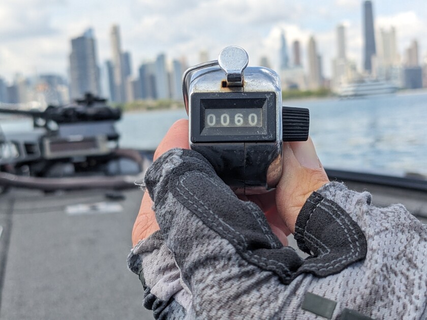 Clicker on the 60th smallmouth bass held with the Chicago skyline as background.