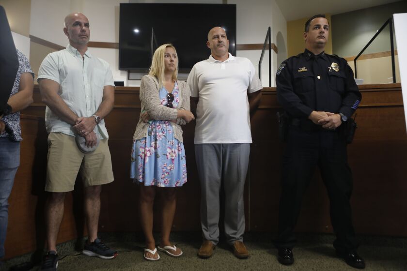 Tara Petito (2L) and Joe Petito look on while the City of North Port Chief of Police Todd Garrison (not seen) speaks during a news conference for their missing daughter Gabby Petito on September 16, 2021 in North Port, Florida.