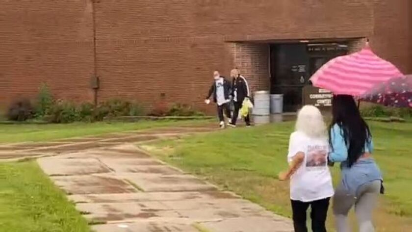 Brothers Juan and Rosendo Hernandez walk out of the Dixon Correctional Center on Friday after spending 25 years in prison for a crime they say they didn’t commit as family members rush toward them.