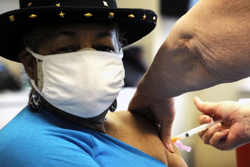 Georgette Moon get a COVID-19 vaccine at the county health department in Tuskegee, Alabama. Moon, a former city council member, said she wanted to protect herself and be a role model to encourage others to get the shot.