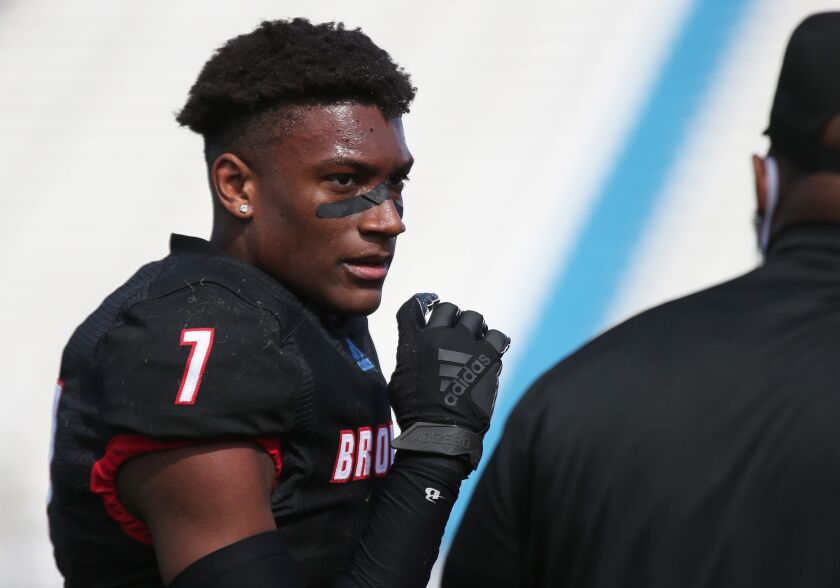 Kenwood’s Jalil Martin (7), a two-way player, catches his breath during a timeout.