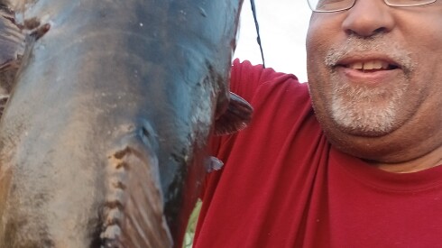 Victor Blackful holds one of the four big catfish he caught fishing the lower end of the Kankakee River.