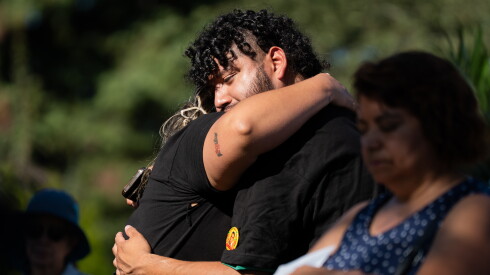 Luis Kevin Islas, founder of Unidos Sembrando Futuro, receives a hug during a mass and memorial commemorating the one-year anniversary of the killing of Silverio Villegas González at the intersection of Grand Avenue and Emerson Street in Franklin Park, Ill., Saturday, Sept. 12, 2026.