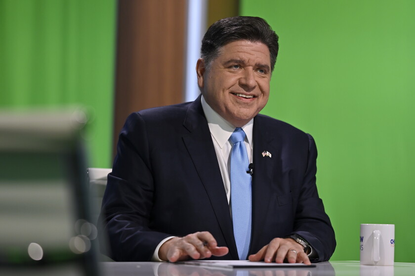 Democratic Gov. JB Pritzker smiles from the anchor table before the live broadcast of the WTTW News Gubernatorial Forum at WTTW’s North Side studios on Tuesday, Oct. 13, 2026, in Chicago. | Victor Hilitski/For the Sun-Times