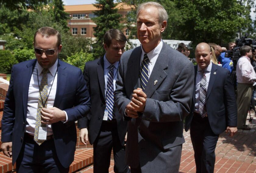 Gov. Bruce Rauner, right, after a press conference on Friday. File Photo. (Rich Saal/The State Journal-Register via AP)
