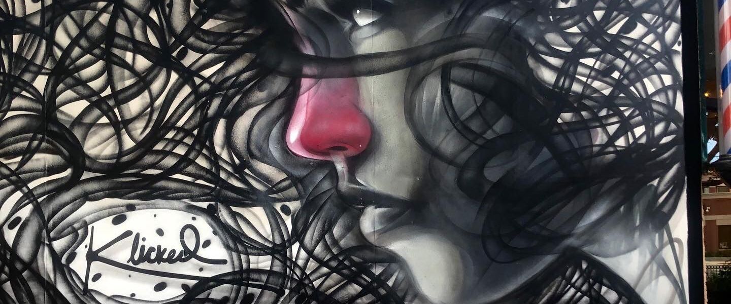 A closeup of one of the mural portraits designed by rawooh, who used red and pink shades for a more realistic look.
