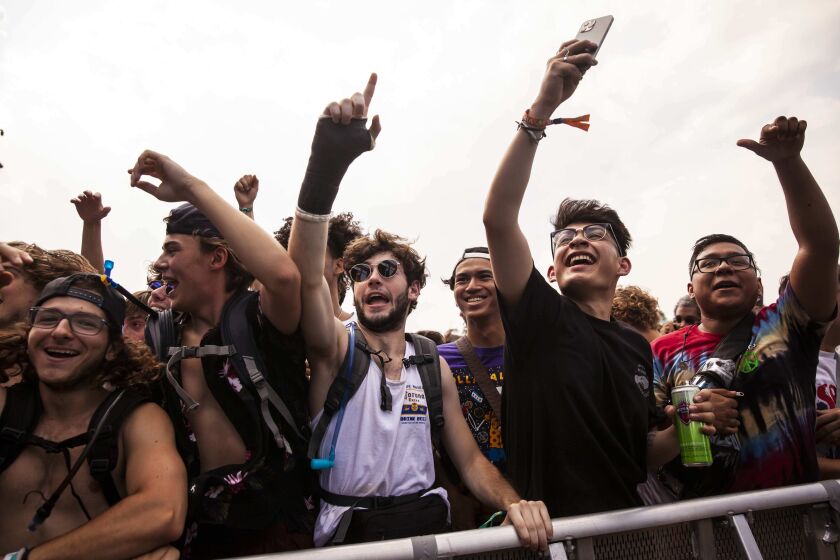 Festival-goers dance and cheer as Supa Bwe performs Friday afternoon on day one of the Summer Smash Festival in Douglass Park.