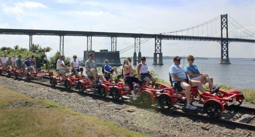 A Rail Explorers tour stops to admire the view by the Mount Hope Bridge in Portsmouth, R.I | (AP Photo/Jennifer McDermott