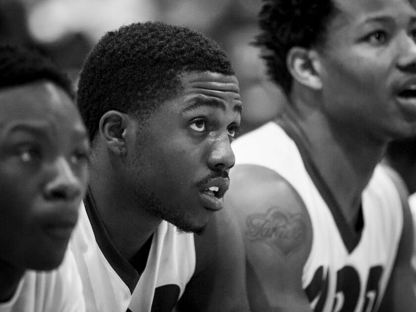 Orr Academy High School’s Alex Flute watches from the bench as his team loses an away game 62-61 against Curie Metropolitan High School, Feb. 15, 2017.