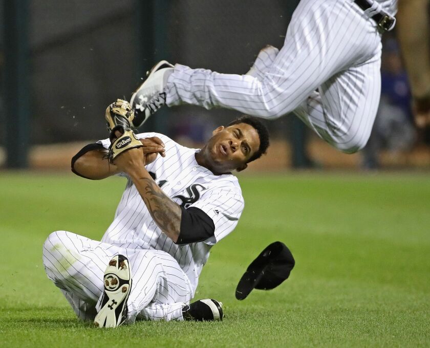 Willy Garcia is hit in the head by teammate Yoan Moncada as they collide going for a ball hit by Darwin Barney of the Toronto Blue Jays in the 6th inning at Guaranteed Rate Field on July 31, 2017 in Chicago, Illinois. (Getty Images)