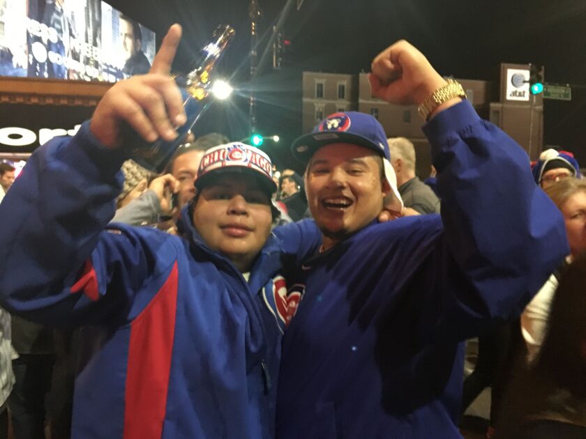 William Rosales (right) celebrating with his friend Ulysses Quijano outside Wrigley Field. | Jacob Wittich / Sun-Times