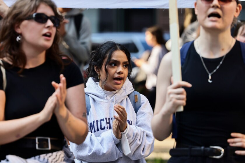 Ivanna Vidal chants along with the larger group during a rally and march in solidarity with protests in Los Angeles against ICE dentition and operations on Tuesday.