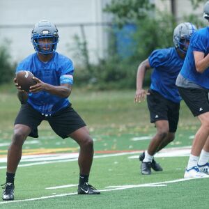 Taft quarterback Dexter Stigall IV hands the ball off during the first practice of the season.