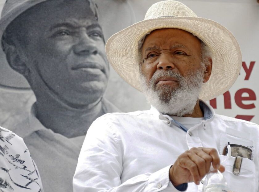 Civil rights activist James Meredith sits in front of a 1966 photograph of himself during a commemoration at the state capitol in Jackson, Miss., of the 50th anniversary of his 1966 “March Against Fear.” | AP