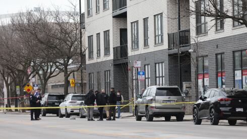 Police officers investigate the 2100 block of West Madison Street.