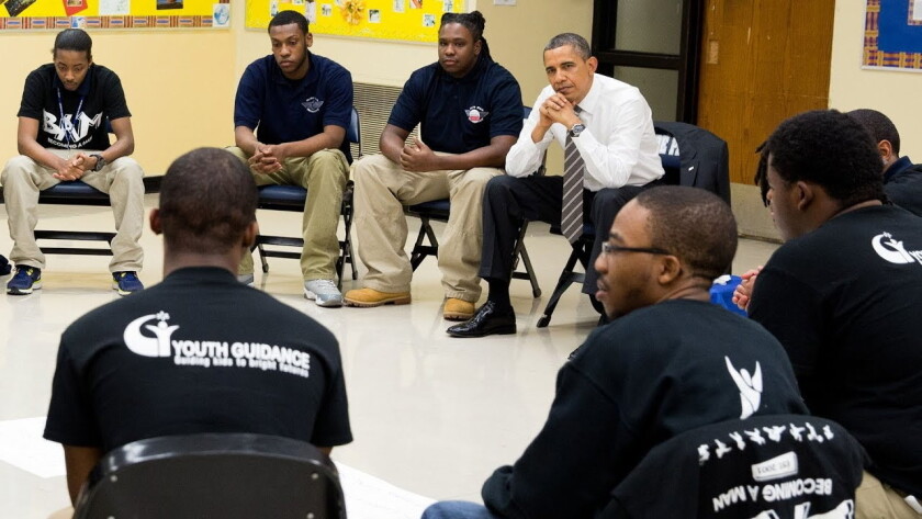 Then-President Barack Obama meets with youths at a BAM meeting at Hyde Park Academy in February 2013. 