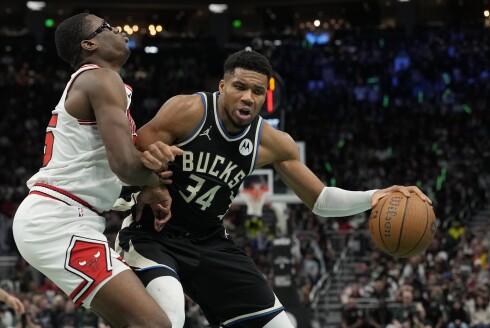 Giannis Antetokounmpo of the Milwaukee Bucks dribbles the ball against Jalen Smith of the Bulls in the fourth quarter of the Emirates NBA Cup game at Fiserv Forum on Nov. 7, 2025, in Milwaukee, Wisconsin.