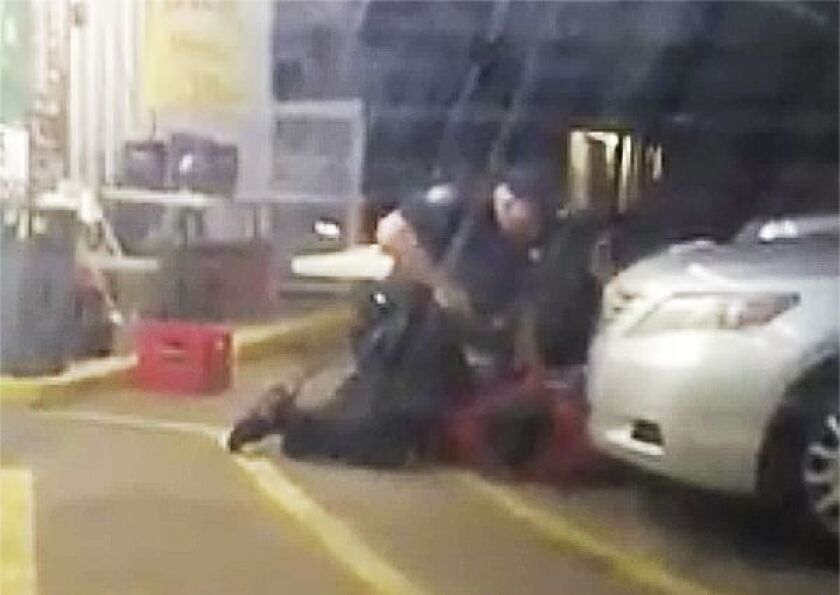 In this photo made from video, Alton Sterling is held by two Baton Rouge police officers, with one holding a handgun, outside a convenience store in Baton Rouge, Louisiana. Moments later, while Sterling was still on the ground, he was shot and killed by o