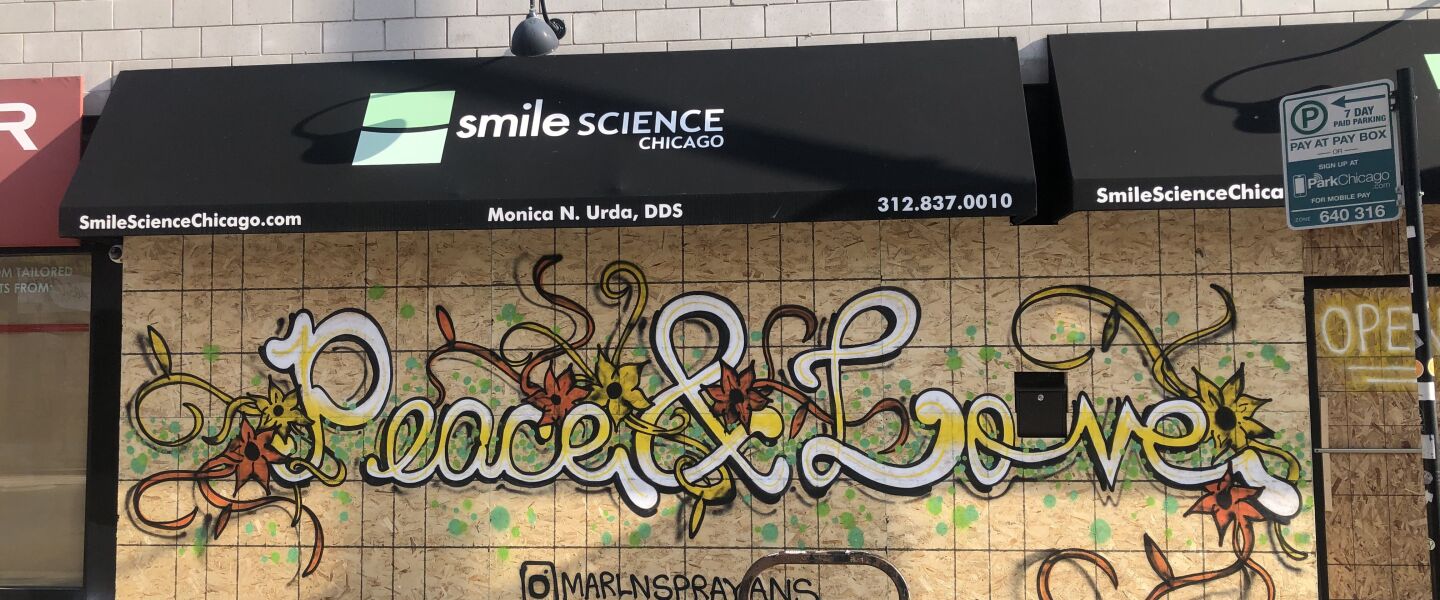 A street artist who goes by the name “Nzyme” painted the phrase “Peace & Love” outside Smile Science Chicago in Wicker Park following the killing of George Floyd by a Minneapolis police officer.