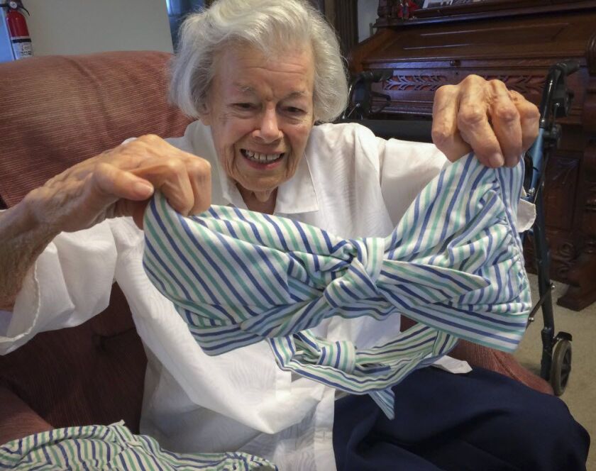 Joan Schechner, 94, is a WWII nurse vet who served in the Pacific theater and remembers the tumult at the news the Japanese had surrendered. She displays the swimsuit she brought with her to war — and still has. | Stefano Esposito / Sun-Times