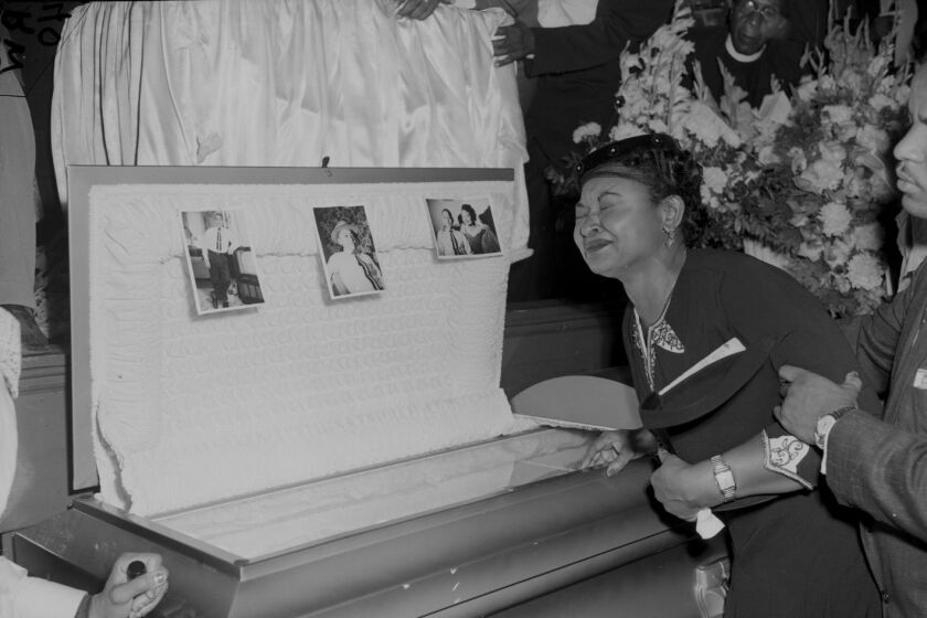 Mamie Till-Mobley beside her son Emmett Till’s casket at his funeral.