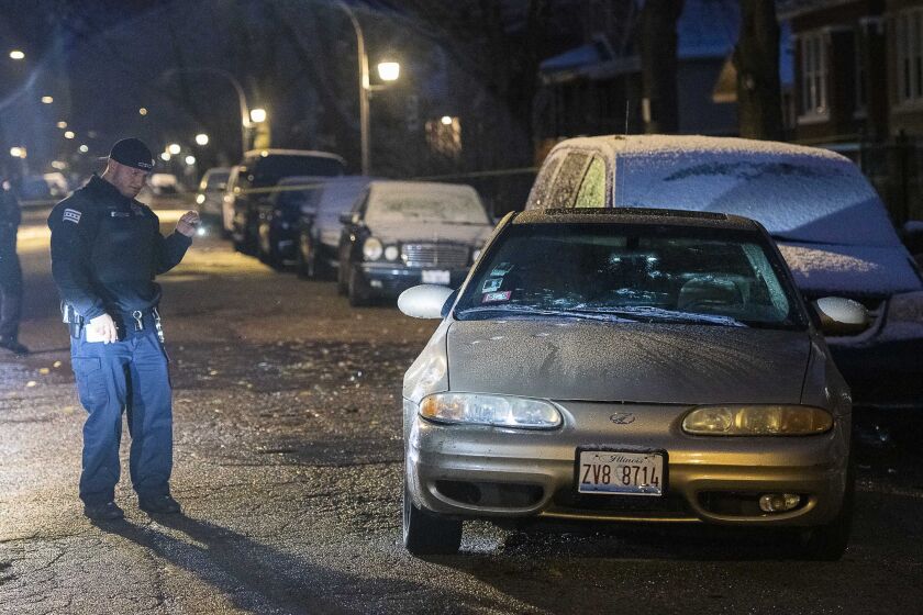 Police investigate the scene where three people were wounded whiled traveling in a vehicle, Sunday morning in the 6500 block of South Hoyne in the Englewood neighborhood. | Tyler LaRiviere/Sun-Times