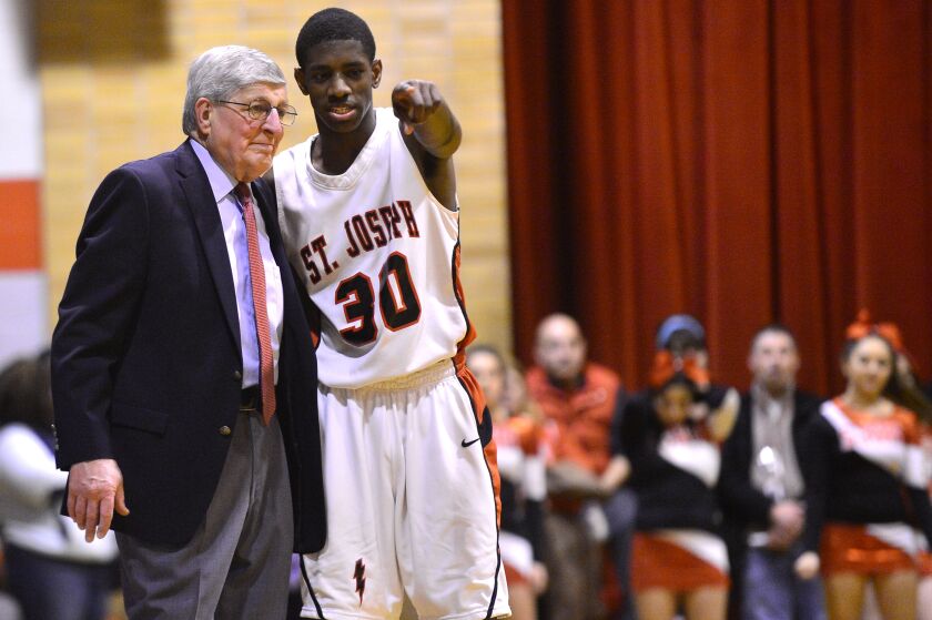 St. Joseph coach Gene Pingatore talks with player Glynn Watson during their game against Fenwick.