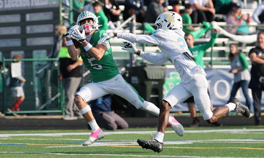 Notre Dame's Peter Panagiotopoulos (5) catches a pass and scores his second touchdown in the first half against Maine West.