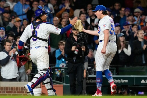 Cubs catcher Miguel Amaya, left, celebrates with relief pitcher Ryan Rolison after the 10th inning against the Cincinnati Reds at Wrigley Field on Tuesday, May 5, 2026.