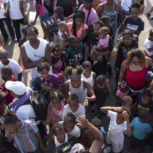Crowds mass behind “anti-bait” trucks for free shoes. | Rick Majewski/For the Sun-Times