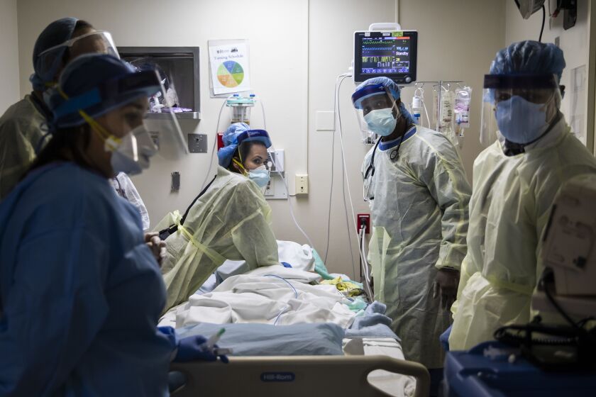 Nurse practitioner Capri Reese (left) watches the monitor for a heart rhythm while respiratory therapist Khafran Alshahin performs chest compressions on an 80-year-old man suffering from the coronavirus. Respiratory therapists Dennis Kelly and Malcolm Love (right), also look at the monitor. The 80-year-old man was one of three patients to die from complications of COVID-19 at Roseland Community Hospital, Tuesday afternoon, April 28, 2020.