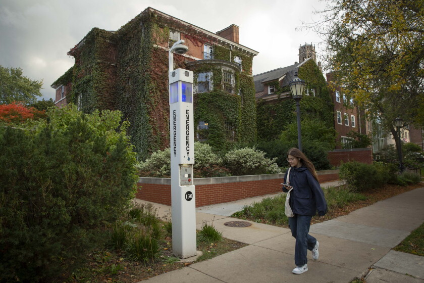 A person walks by an emergency call station on the University of Chicago campus Friday. The university has been thrust into the national conversation about how to address sexual violence on college campuses after two reports of sexual assaults at fraternity houses near the campus.