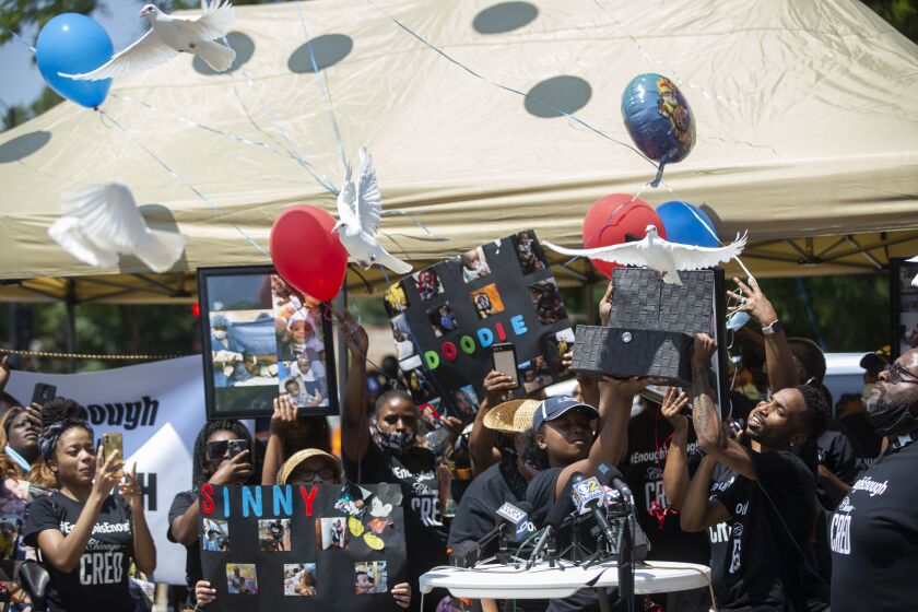 Family members release doves and balloons for 20-month-old Sincere Gaston during a vigil near the corner of West 61st and South Halsted streets, not far from the spot where Sincere was shot to death, in Englewood, Wednesday afternoon, July 1, 2020. Gaston was shot in the chest while riding in a car driven by his mother on June 27.