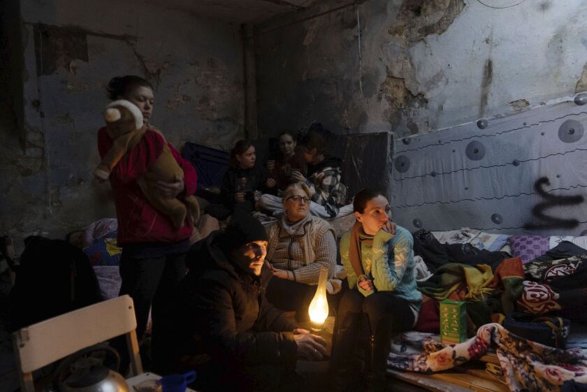 People settled in a bomb shelter in Mariupol, Ukraine.