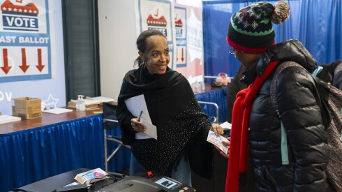 Carley Smelser, an election judge, assists a voter in casting her ballot for the primary election at the early voting supersite in the Loop, Thursday, Feb. 12, 2026. | Pat Nabong/Sun-Times