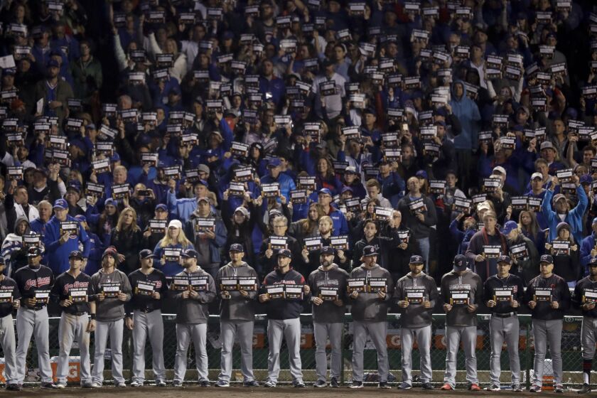 <em>Cleveland Indians players hold up stand up to cancer signs during the fifth inning. (AP Photo/Charles Rex Arbogast)</em>