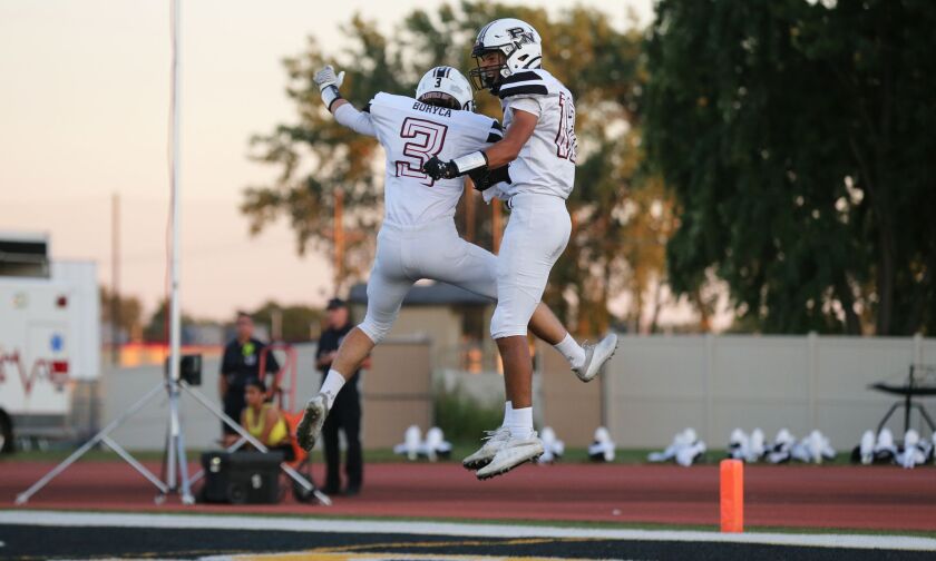 Plainfield North’s Braxton Bartz, right, and Jaxon Boryca celebrate after one of Bartz’s touchdowns against Joliet West.