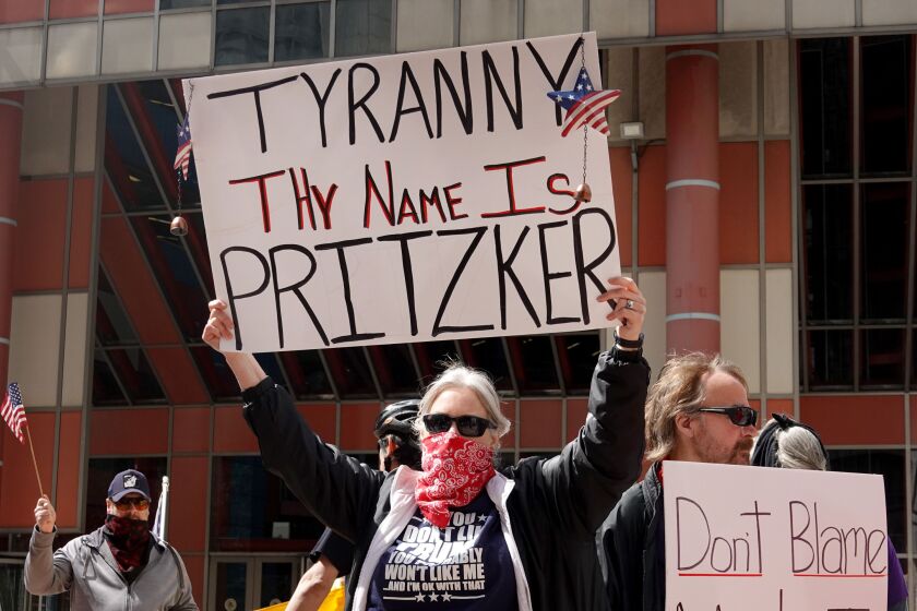 Demonstrators gather outside of the Thompson Center in May to protest restrictions instituted by Gov. J.B. Pritzker in an attempt to curtail the spread of the coronavirus.