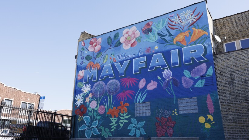 The "Welcome to Mayfair" by Erin Minckley features orange lilies, pink tulips, lavender irises, purple lavender and more.