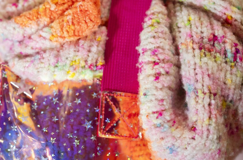 An attendee carries a sweater in a bag during the 19th YarnCon at the Plumbers Union Hall in the Near West Side on Saturday.