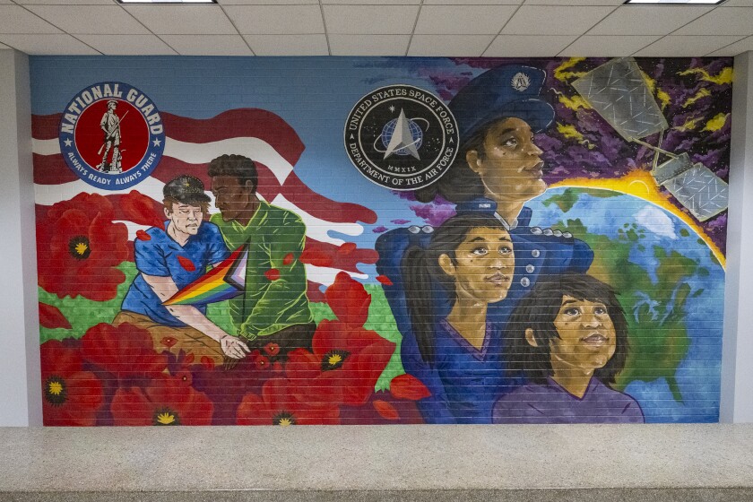 This mural by Ali Cantarella shows a woman in the U.S. Space Force with two younger versions of herself.
