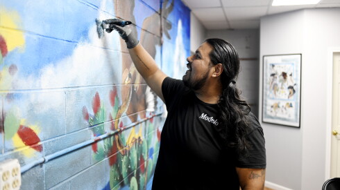 Muralist Mr. Pintamuro works on a mural at Te-Qu’s new location in Chicago’s Little Village neighborhood.