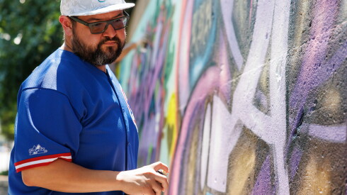 Ole Flores works on his graffiti on a mural on Green Bay Road between Foster Street and Simpson Street in Evanston.