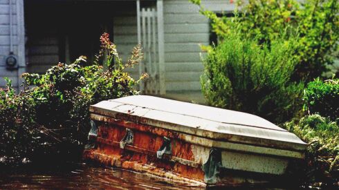 A casket floats in a flooded yard in Princeville, N.C., on Sept. 22, 1999, in the aftermath of Hurricane Floyd. Two hurricanes 17 years apart created catastrophic flooding in the town, which was built on swampy land.