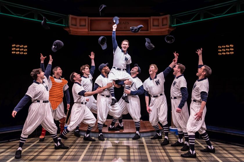 The Washington Senators’ sensational new young player Joe Hardy (Andrew Alstat) is celebrated by his teammates in “Damn Yankees” at the Marriott Theatre in Lincolnshire.