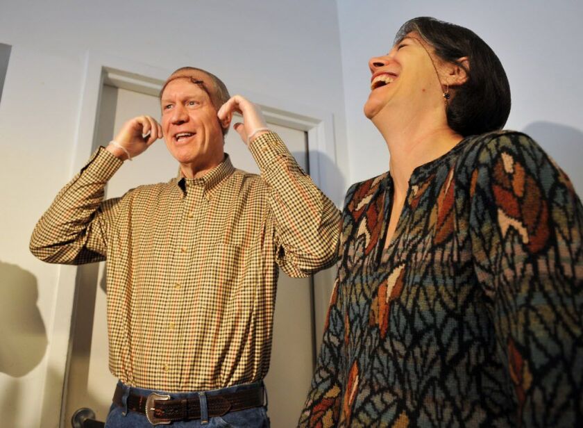 Then governor-elect Bruce Rauner and wife Diana Rauner share a laugh while putting on hair nets to distribute Thanksgiving dinner at A Safe Haven in November of 2014. File Photo by Al Podgorski/Sun-Times Media