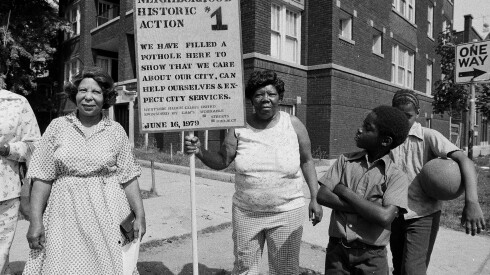 Block club filling a pothole in West Garfield Park at West Van Buren and South Springfield Avenue in 1979,